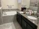 Bathroom featuring double sinks, granite countertops, and a separate soaking tub at 4183 Cortland Dr, Davenport, FL 33837