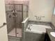 Well-lit bathroom featuring a separate shower and a luxurious soaking tub at 4183 Cortland Dr, Davenport, FL 33837