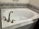 Close up of relaxing soaking tub with modern fixtures and decorative tile surround at 4183 Cortland Dr, Davenport, FL 33837