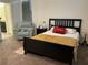 Cozy bedroom featuring a queen-sized bed, sitting chair, and bedside table at 4183 Cortland Dr, Davenport, FL 33837