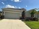 Charming home featuring a spacious two-car garage and well-maintained landscaping with a vibrant green lawn at 4183 Cortland Dr, Davenport, FL 33837