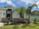 Charming single-story home with a well-manicured lawn, decorative stone accents, and vibrant flowering plants at 4183 Cortland Dr, Davenport, FL 33837