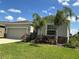 Charming home with a well-manicured lawn, lush landscaping, and a cozy exterior highlighted by decorative stone accents at 4183 Cortland Dr, Davenport, FL 33837
