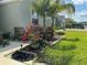 Beautifully landscaped front yard with flowers, bushes and palm trees at 4183 Cortland Dr, Davenport, FL 33837