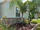 This home features lush landscaping with vibrant plants, mulch and green grass, enhancing its curb appeal at 4183 Cortland Dr, Davenport, FL 33837