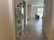 Hallway with neutral tile floors leads to an open living space at 4183 Cortland Dr, Davenport, FL 33837