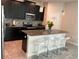 Modern kitchen with stainless steel appliances, granite countertops, and a stylish center island with seating at 4183 Cortland Dr, Davenport, FL 33837
