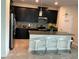 Modern kitchen with stainless steel appliances, granite countertops, island and dark wood cabinetry at 4183 Cortland Dr, Davenport, FL 33837