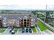 Aerial view of a modern apartment complex featuring a parking lot and lush landscaping at 2217 Grand Cayman Ct # 1233, Kissimmee, FL 34741