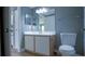 Bathroom features a spacious vanity with a single sink, toilet, and tiled floors at 2217 Grand Cayman Ct # 1233, Kissimmee, FL 34741
