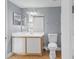 Bathroom with a vanity, mirror, toilet, and tile flooring, providing a clean and functional space at 2217 Grand Cayman Ct # 1233, Kissimmee, FL 34741