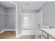 Bright bathroom featuring a shower-tub combo and a walk-in closet for ample storage at 2217 Grand Cayman Ct # 1233, Kissimmee, FL 34741