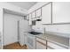 Well-lit kitchen with white cabinets, modern appliances, and tiled floors at 2217 Grand Cayman Ct # 1233, Kissimmee, FL 34741