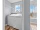 Dedicated laundry area with washer, dryer, and wire shelving for easy storage at 2217 Grand Cayman Ct # 1233, Kissimmee, FL 34741