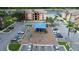 Aerial view of playground at apartment complex featuring colorful play structure and surrounding parking area at 2217 Grand Cayman Ct # 1233, Kissimmee, FL 34741