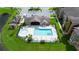 Aerial view of a community pool and clubhouse in lush green surroundings at 2217 Grand Cayman Ct # 1233, Kissimmee, FL 34741