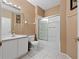 Bathroom with a single sink vanity, a sliding door shower, and white tiled floor at 3222 Stonehurst Cir, Kissimmee, FL 34741