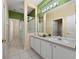 Bathroom with a single sink vanity, white tiled floors and a glass door shower at 3222 Stonehurst Cir, Kissimmee, FL 34741