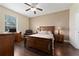 Hardwood floors in this bedroom with large window, ceiling fan, and neutral walls at 3222 Stonehurst Cir, Kissimmee, FL 34741