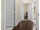 Hallway with hardwood floors with views of a bathroom and the living room at 3222 Stonehurst Cir, Kissimmee, FL 34741