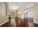 Spacious living room with hardwood floors, a large window and view into the kitchen at 3222 Stonehurst Cir, Kissimmee, FL 34741
