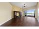 Hardwood floors in the living room with ceiling fan, and sliding glass doors leading to the lanai at 3222 Stonehurst Cir, Kissimmee, FL 34741