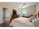Primary bedroom with a large window, hardwood floors, ceiling fan and a walk-in closet at 3222 Stonehurst Cir, Kissimmee, FL 34741