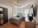 A comfortable bedroom featuring a large bed, stylish decor, and natural light from the window at 5906 Rywood Dr, Orlando, FL 32810
