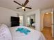 Bright bedroom with a ceiling fan, television, and mirrored sliding closet at 5906 Rywood Dr, Orlando, FL 32810