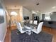The dining room has wood floors, a glass table with white chairs, and opens to other rooms at 5906 Rywood Dr, Orlando, FL 32810