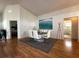 The dining room features a glass table with white chairs and decor on wood floors at 5906 Rywood Dr, Orlando, FL 32810