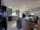 Stylish kitchen with sleek gray cabinets, stainless steel appliances, granite countertops, and a spacious layout at 5906 Rywood Dr, Orlando, FL 32810