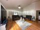 Cozy living room with hardwood floors, two sofas, a glass coffee table and area rug at 5906 Rywood Dr, Orlando, FL 32810
