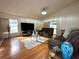 Bright living room with hardwood floors, sofa, a glass coffee table and area rug at 5906 Rywood Dr, Orlando, FL 32810
