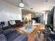 Cozy living room showcasing hardwood floors and modern decor, leading to an open kitchen with a large island at 5906 Rywood Dr, Orlando, FL 32810