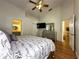 Spacious main bedroom with hardwood floors, offering access to a bathroom and kitchen, with an open layout at 5906 Rywood Dr, Orlando, FL 32810
