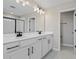 Double vanity bathroom with white cabinets and black hardware at 899 Griffon Ave, Lake Alfred, FL 33850