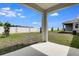 Expansive backyard featuring a covered patio area, lush grass, and a privacy fence perfect for outdoor activities at 1647 Sugarbelle Cir, Mascotte, FL 34753