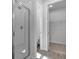 Sleek bathroom featuring a glass-enclosed shower with tile surround and a view into the adjacent closet at 1647 Sugarbelle Cir, Mascotte, FL 34753