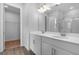 Modern bathroom with a double sink vanity, wood tile flooring, and a separate water closet for added privacy at 1647 Sugarbelle Cir, Mascotte, FL 34753