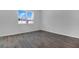 Bright bedroom with wood tile flooring and a window allowing natural light at 1647 Sugarbelle Cir, Mascotte, FL 34753