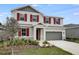 Charming two-story home with red shutters and landscaped front yard, enhancing curb appeal at 1647 Sugarbelle Cir, Mascotte, FL 34753