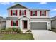 Charming two-story home with red shutters and manicured landscaping, showcasing curb appeal at 1647 Sugarbelle Cir, Mascotte, FL 34753