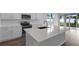 Bright, modern kitchen with stainless steel appliances, white cabinetry, and a center island at 1647 Sugarbelle Cir, Mascotte, FL 34753