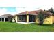 A sunny backyard with a screened porch and lush landscaping; perfect for outdoor living at 9549 Sw 53Rd Cir, Ocala, FL 34476