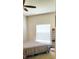 Bright bedroom featuring a ceiling fan, a window with blinds, and neutral decor at 9549 Sw 53Rd Cir, Ocala, FL 34476