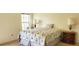 Comfortable bedroom with natural light, a queen bed, and neutral decor at 9549 Sw 53Rd Cir, Ocala, FL 34476
