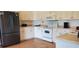 Bright kitchen with white cabinets, a stainless-steel refrigerator, and modern appliances at 9549 Sw 53Rd Cir, Ocala, FL 34476