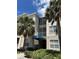 A condo building with a blue awning and palm trees in front of the building at 3301 Whitestone Cir # 308, Kissimmee, FL 34741