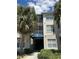 A condo building with a blue awning and palm trees in front of the building at 3301 Whitestone Cir # 308, Kissimmee, FL 34741